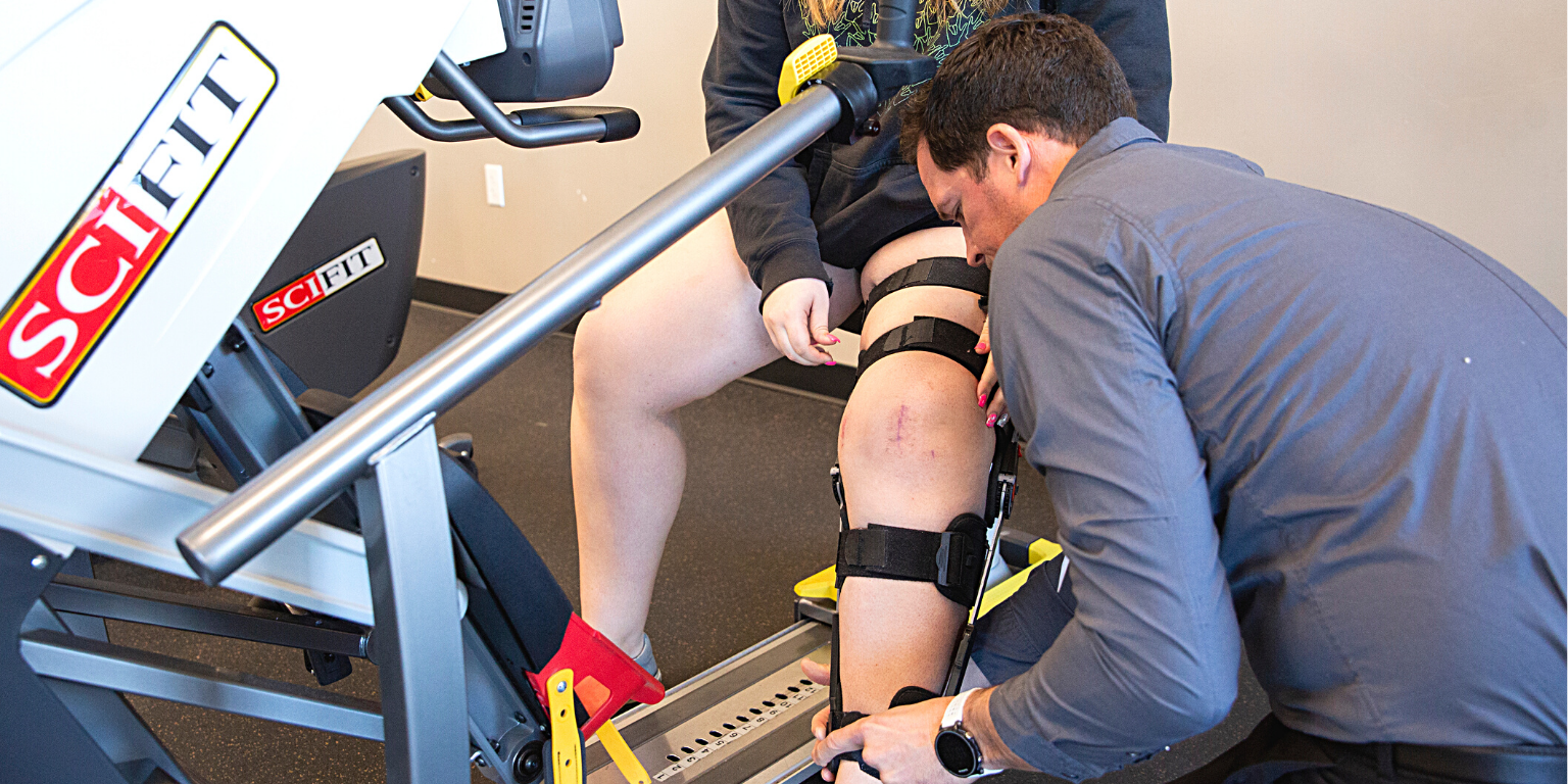 PRO~PT therapist helps a patient who underwent knee surgery