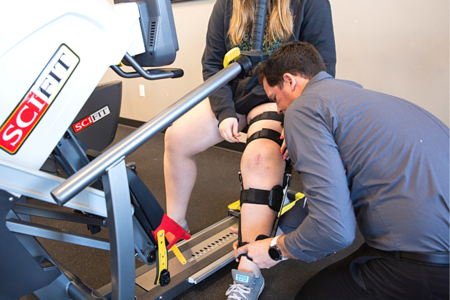 PRO~PT therapist helps a patient who underwent knee surgery