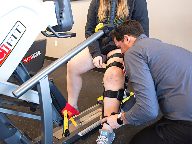 PRO~PT therapist helps a patient who underwent knee surgery