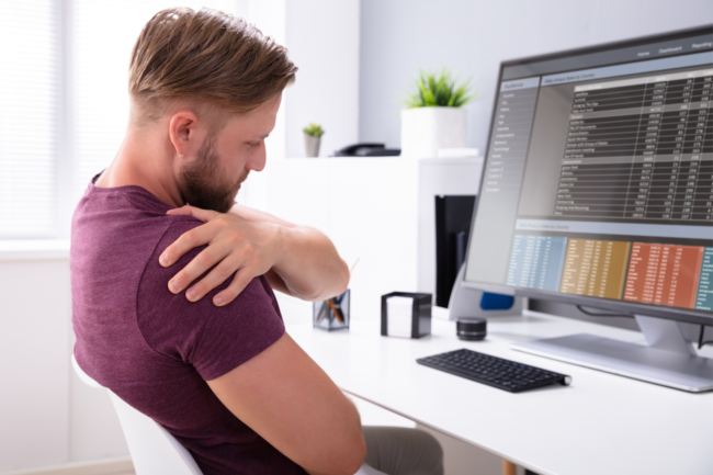Worker has shoulder pain while sitting at a desk.