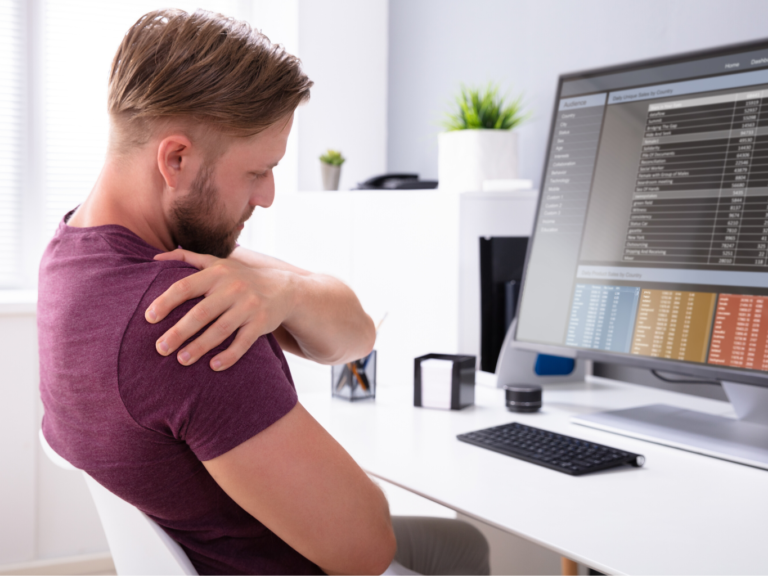 Worker has shoulder pain while sitting at a desk.