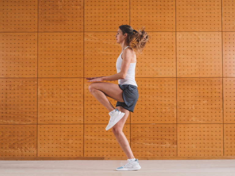 Woman performing a knee raise exercise to help relieve patellar tendonitis