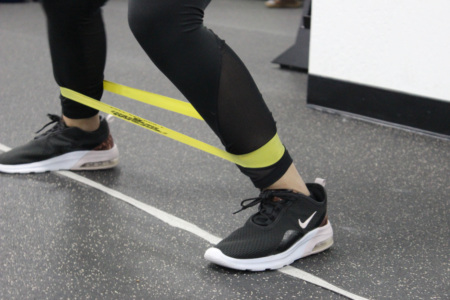 A woman performs exercises directed by a physical therapist