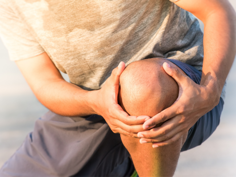 A runner holds his knee due to inner knee pain