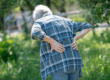 Woman hunches over due to back pain