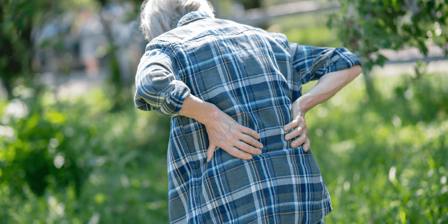 Woman hunches over due to back pain