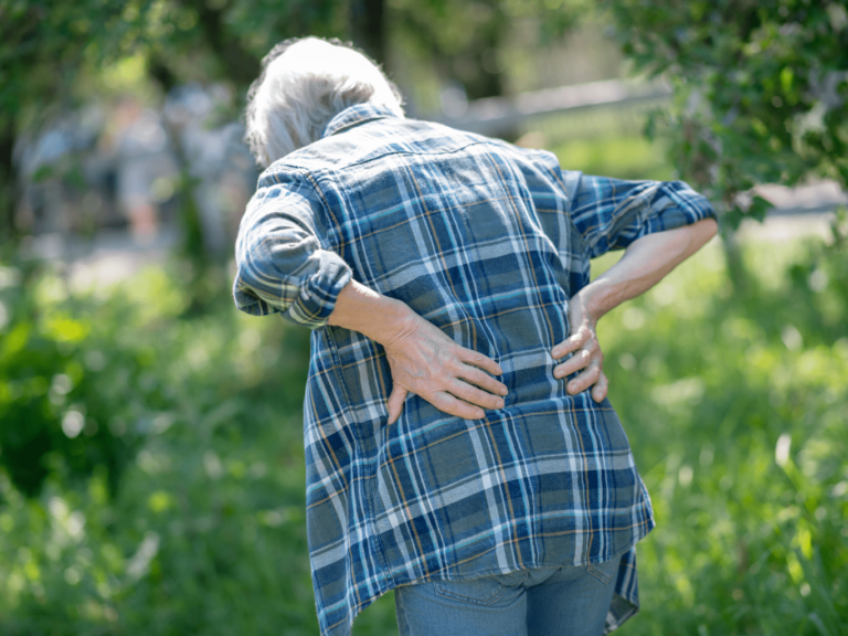 Woman hunches over due to back pain