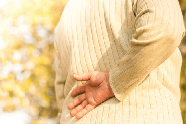 Woman holds her lower back due to pain