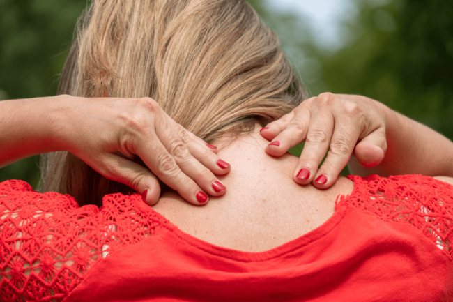 Woman dealing with stiff neck pain