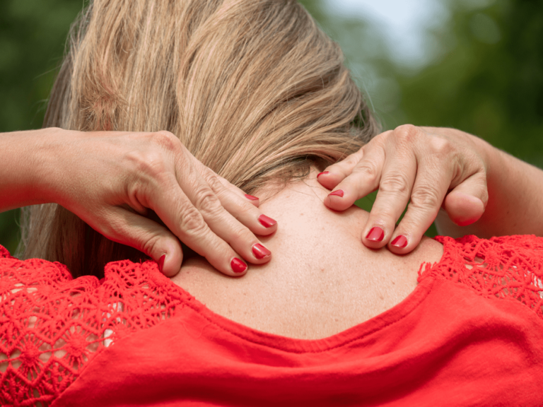 Woman dealing with stiff neck pain