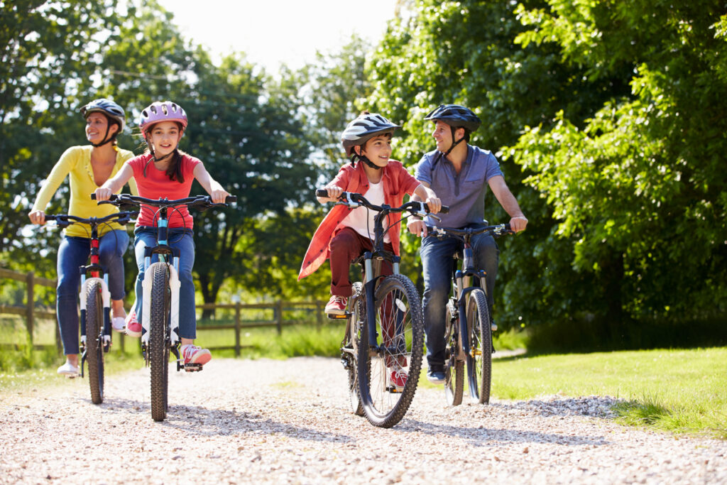 Hispanic Family On Cycle Ride In Countryside