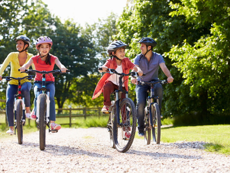 Hispanic Family On Cycle Ride In Countryside
