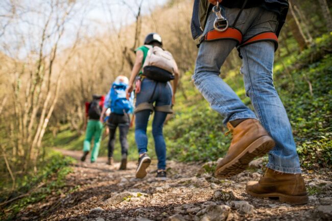 Ground view looking up at hikers heading up a trail
