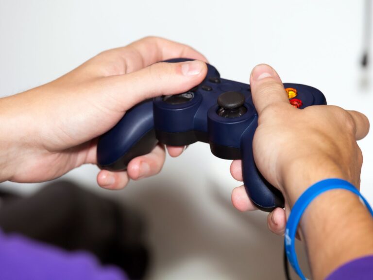 Closeup of hands using a video game console controller