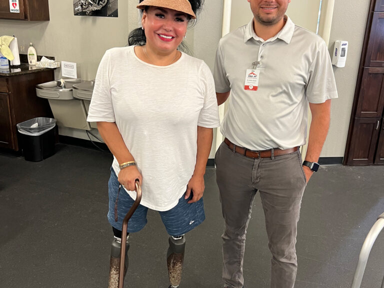 Andrea smiling and standing next to a PRO PT physical therapist