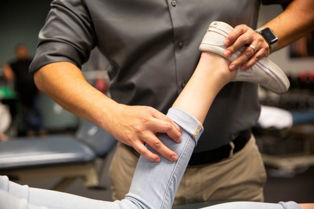 Physical therapist working on a dancers leg