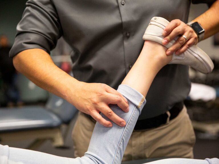 Physical therapist working on a dancers leg