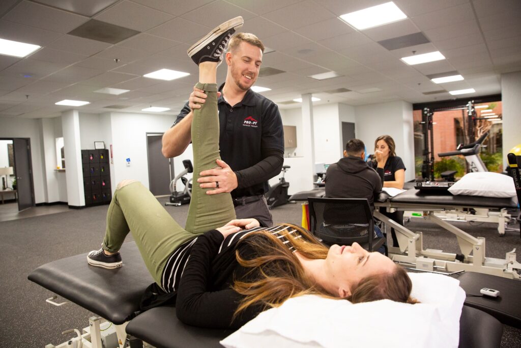 Male physical therapist working with female patient