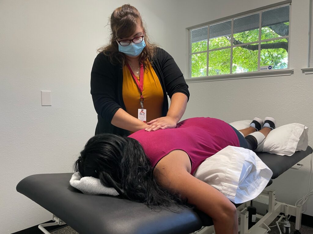 Female physical therapist working with female patient