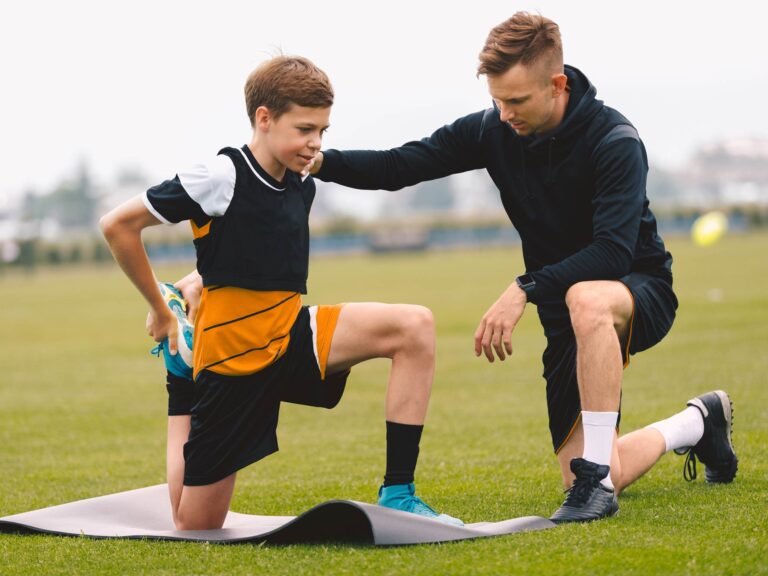Student athlete having a stretching session with physical therapist
