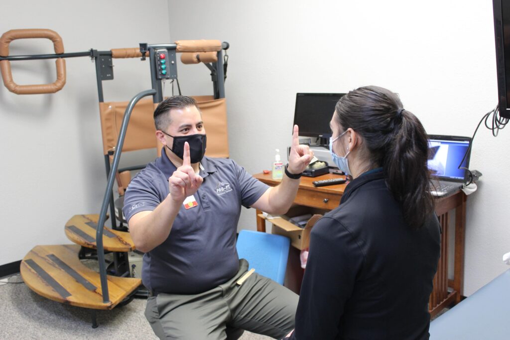 Pro~PT therapist performing responsiveness tests on patient.
