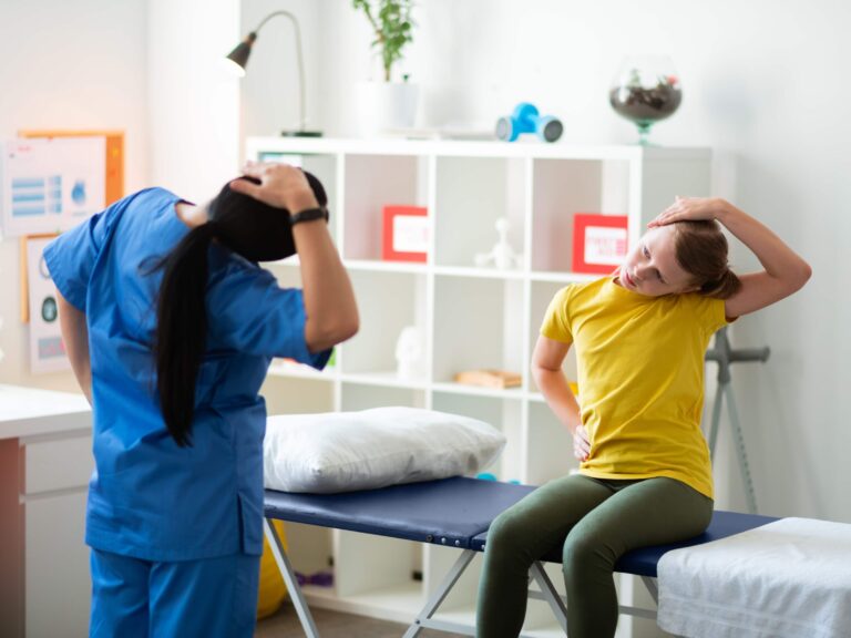 Therapist performing head and neck exercises with patient.