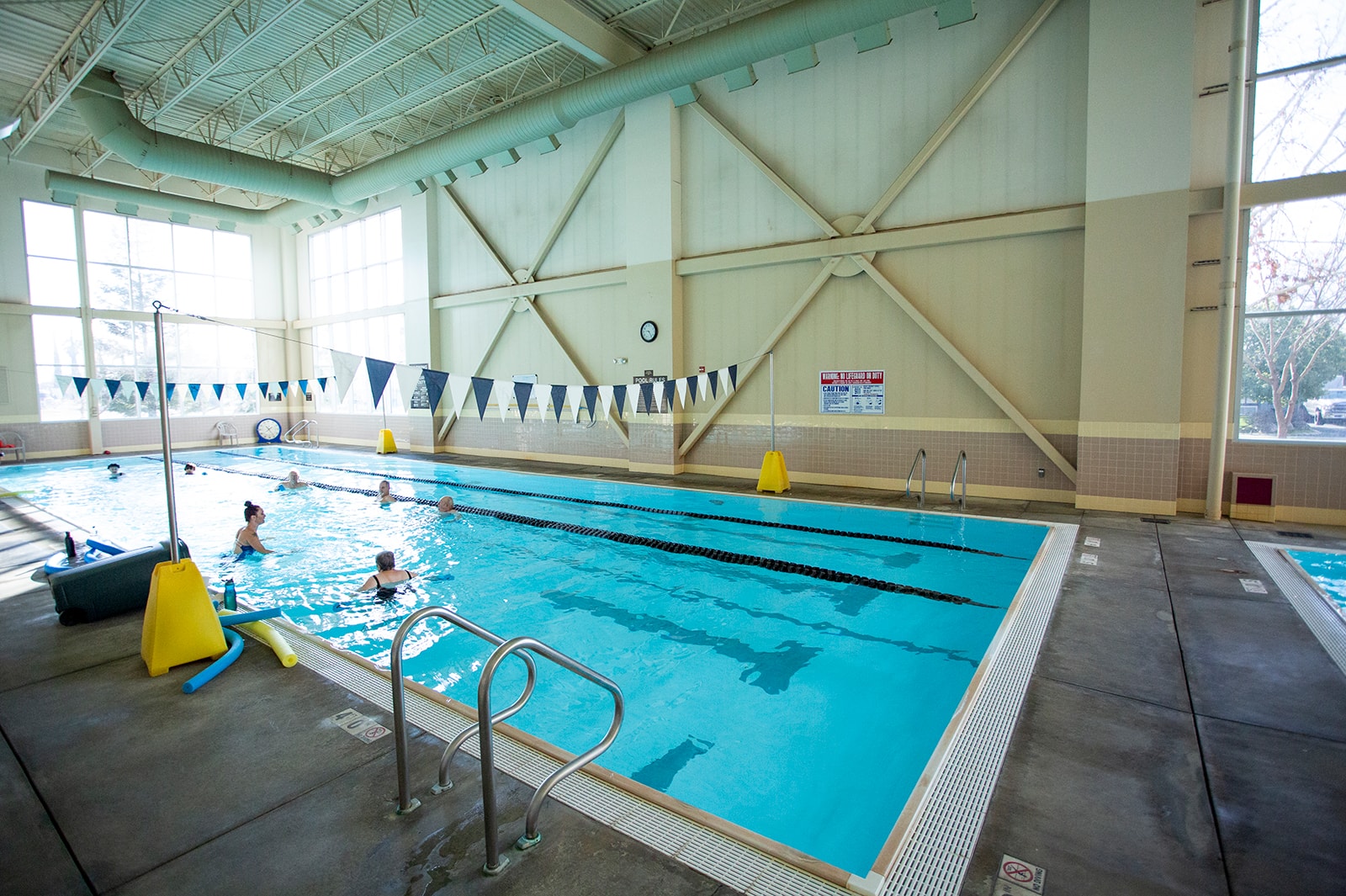 Physical therapist assisting patient in pool