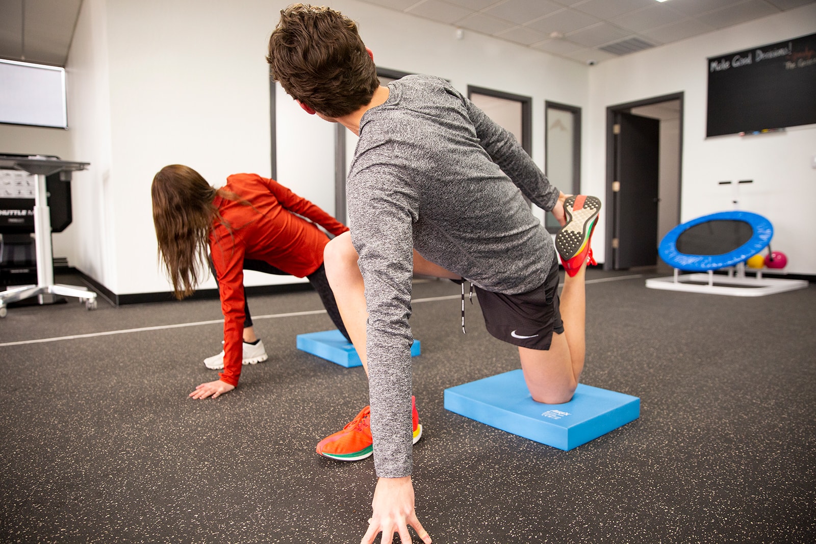 Physical therapist evaluating running form with high-speed camera analysis