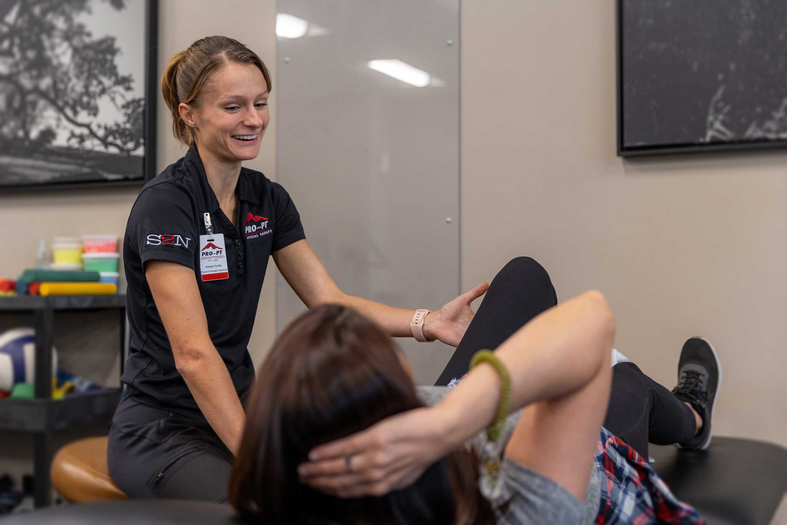 Physical therapist assisting a client